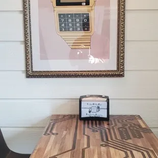 a digital clock on a wooden table