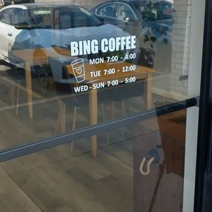 a sign in the window of a coffee shop
