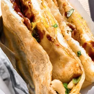 a hot dog in a bun with cheese and ketchup