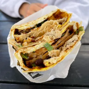 a person holding a tasty looking sandwich