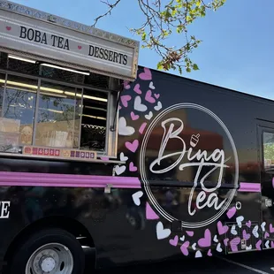 a woman standing in front of a food truck