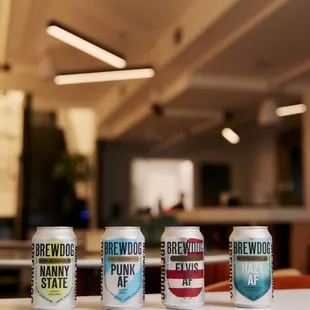 a row of beer cans on a table