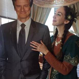 a man in a suit and a woman in a green dress