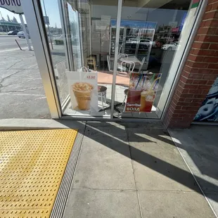 a person's hand reaching for a donut