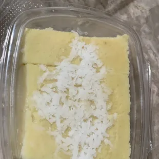 a plastic container with a piece of cake in it