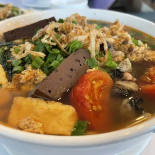 a bowl of soup with meat and vegetables