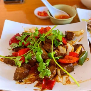 a plate of beef and vegetables