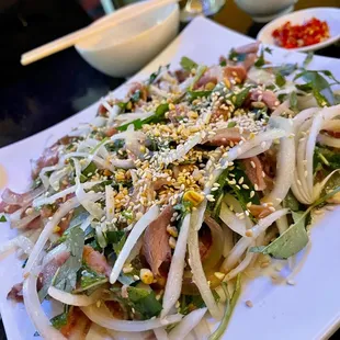 a white plate with a salad on it