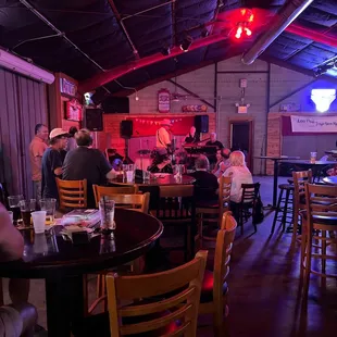 people sitting at tables in a restaurant