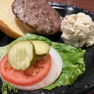 a hamburger, lettuce, and pickle