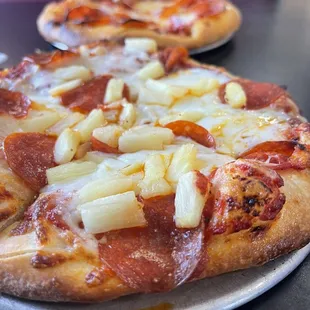 two pizzas on a table