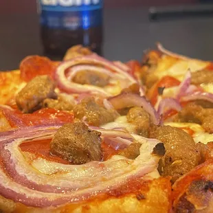 a pizza with onions and meat