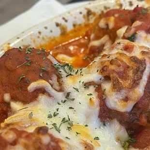 a pizza with meatballs and cheese