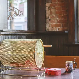 a wooden table with a metal bin on it