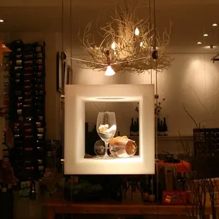 a display of wine bottles and a wine glass