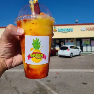 a hand holding a drink