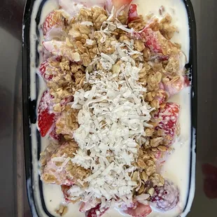 Strawberry and banana bionico with granola and coconut shavings
