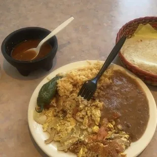 a plate of mexican food and a cup of coffee