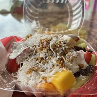 a fruit salad in a plastic container