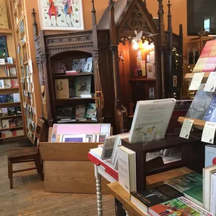 Confessional converted into a display case for art and books.