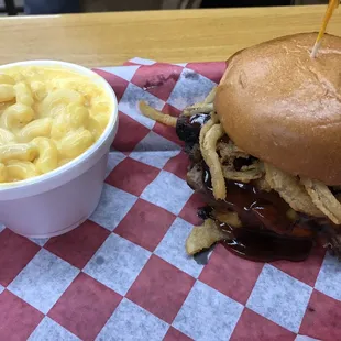 a pulled pork sandwich with macaroni and cheese