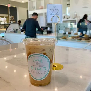 a cup of iced coffee on a table