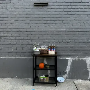 a shelf of food on the side of a building