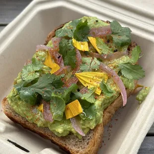 avocado toast in a styrofoam container