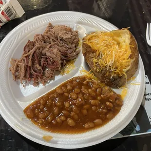 Brisket entrée with a loaded baked potato and baked beans