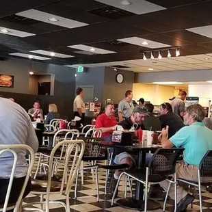 people sitting at tables in a restaurant