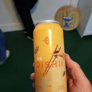 a hand holding a can