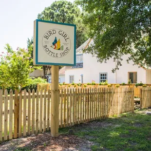 a sign in front of a fence