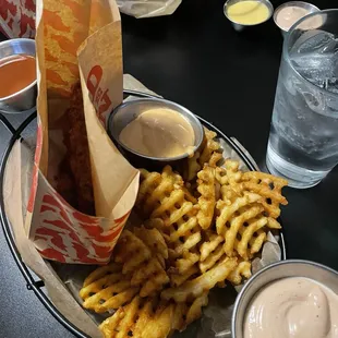 a plate of french fries and dips