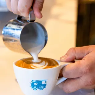 Cappuccino being poured at Bird Rock Coffee Roasters Encinitas