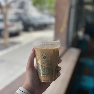 a hand holding a cup of coffee