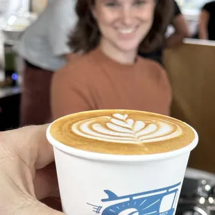 a person holding a cup of coffee