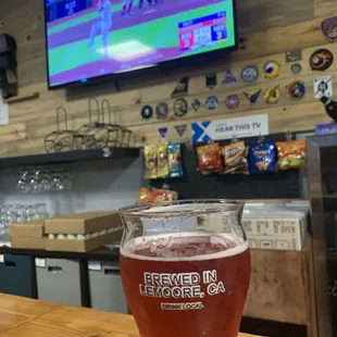 a glass of beer on a bar