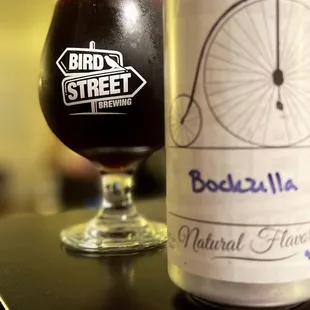 a glass of beer next to a bottle of beer