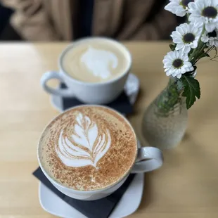 Top: Hot vanilla latte  Bottom: Hot caramel latte with a sprinkle of cinnamon on top