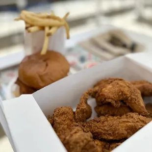 a box of fried chicken and a burger