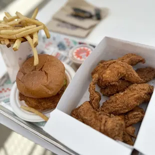 a tray of fried chicken and a burger