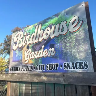 a sign for a birdhouse garden