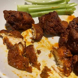 chicken wings and celery on a plate