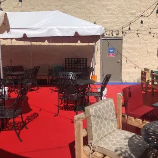 tables and chairs on a red carpet