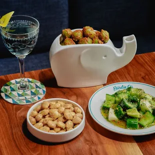 Sky's the Limit cocktail, marinated olives, lavender almonds and smashed cucumbers