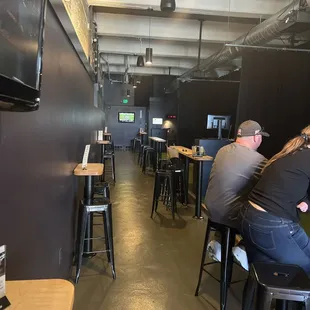 people sitting at tables in a restaurant