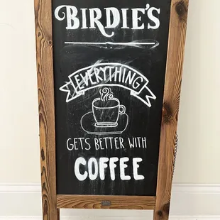 a blackboard with a coffee sign