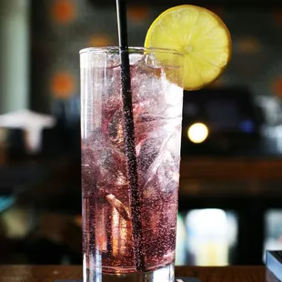 a glass of soda with a slice of lemon