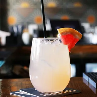 a drink with a slice of grapefruit