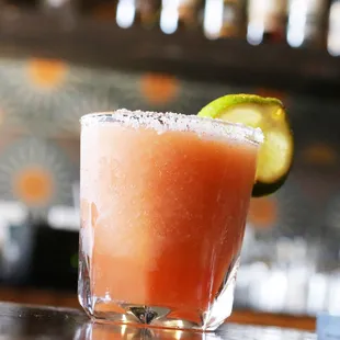 a margarita with a lime wedge